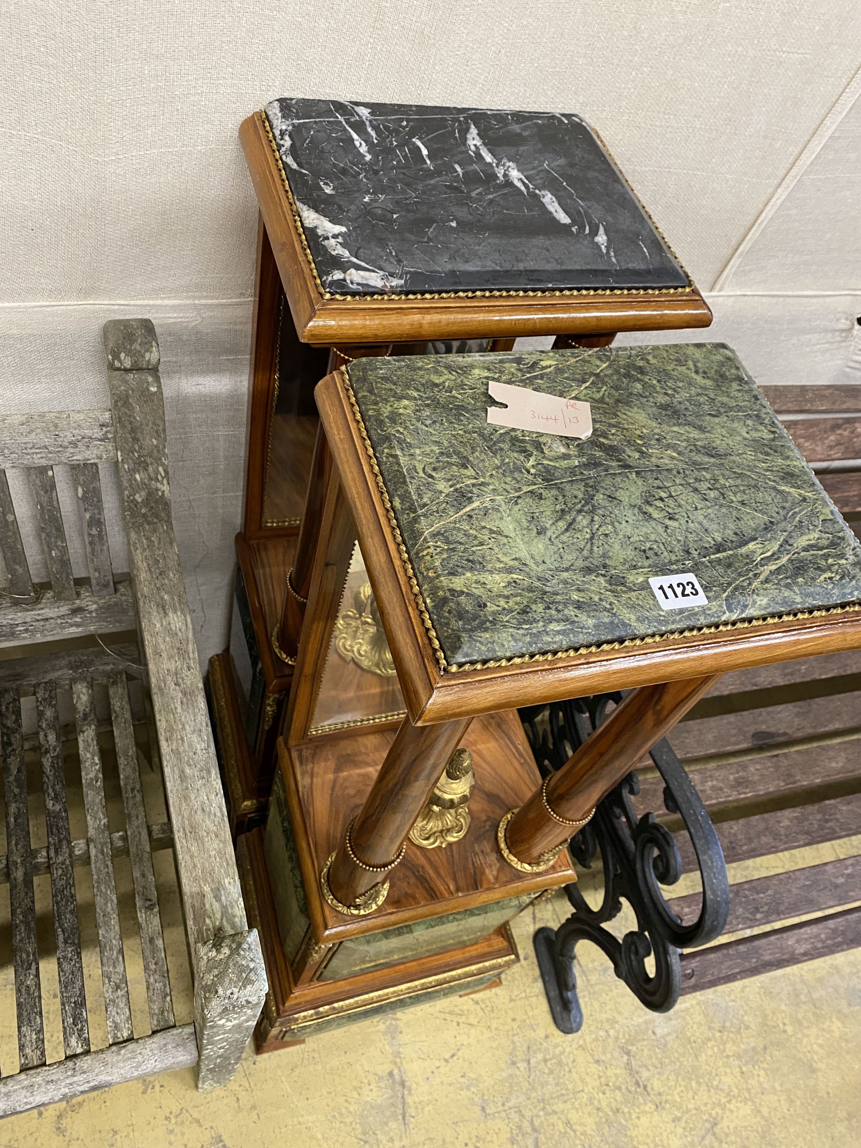 A near pair of Empire style gilt metal mounted walnut mirrored pier tables, (lacks one finial) width 34cm, depth 24cm, height 109cm